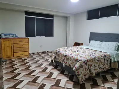 a bedroom with a bed and a dresser in it at comfortable magic apartment in San Juan Bautista