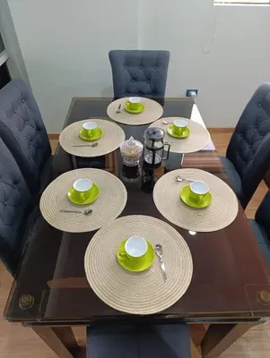 a wooden table with plates and cups on top at Sumaq Sky in Cusco