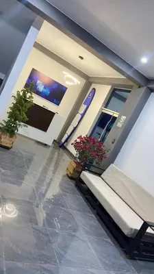 a lobby with a bench and flowers in a building at Ocean Home in San Juan de Marcona