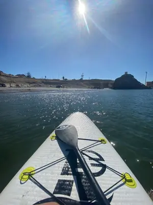 a paddle boat on a body of water with the sun at Ocean Home in San Juan de Marcona
