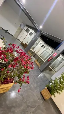 a view of a room with red flowers and tables at Ocean Home in San Juan de Marcona