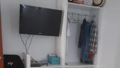 a tv hanging on a wall in a room at Tiki in San Bartolo