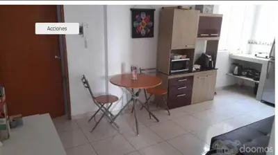a kitchen with a table and chairs in a room at Tiki in San Bartolo