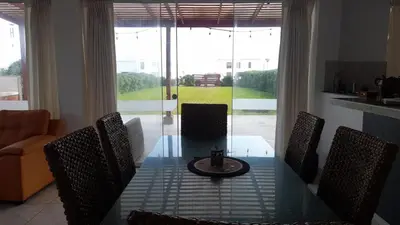 a dining room table with chairs and a tableasteryasteryasteryasteryasteryasteryastery at Casa frente al mar in Lurín