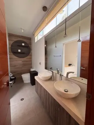 a bathroom with two sinks and a large mirror at Villa Luquin in Hacienda Santo Domingo