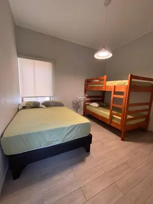 a bedroom with a bed and two bunk beds at Villa Luquin in Hacienda Santo Domingo