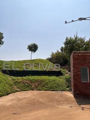 a sign that says ovation in front of a bush at Villa Luquin in Hacienda Santo Domingo