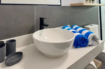 a white sink on a counter in a bathroom at Tiny House con Jacuzzi, Fogata y Starlink in Anta