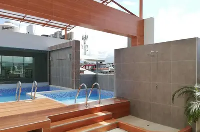 a bathroom with a tub and a swimming pool at Hotel Cerro Azul in La Merced