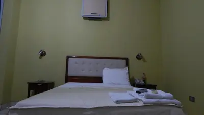 a bedroom with a bed with towels on it at Hotel Cerro Azul in La Merced