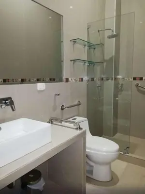 a bathroom with a toilet and a sink and a shower at Hotel Cerro Azul in La Merced