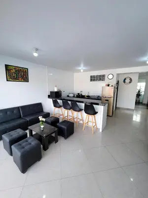 a living room with a couch and chairs and a kitchen at Casa Bujama Playa y Piscina Privada in Bujama Baja