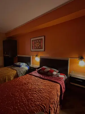 a hotel room with two beds in a room at Hospedaje Don Luciano in San Vicente de Cañete
