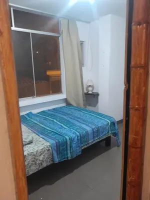 a small bedroom with a bed and a window at Minidepa San Bartolo in San Bartolo