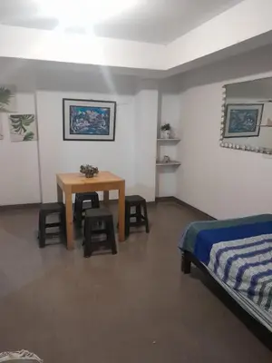a bedroom with a bed and a table and chairs at Minidepa San Bartolo in San Bartolo