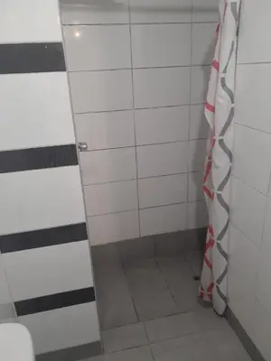 a shower with a glass door in a bathroom at Minidepa San Bartolo in San Bartolo