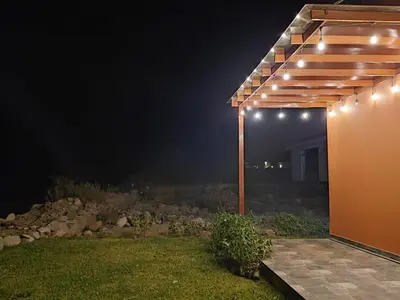 a pergola with lights on it at night at Casa de Campo en Santa Rosa de Quivez in Santa Rosa de Quives