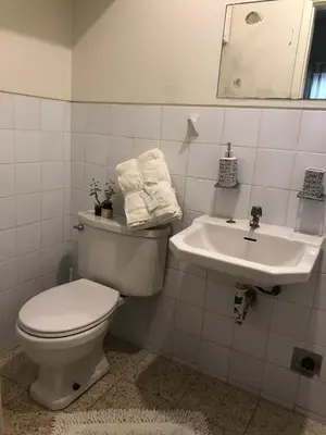 a bathroom with a toilet and a sink at Miraflores kennedy view in Lima