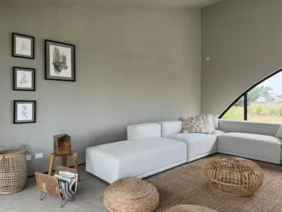 a living room with a white couch and a large window at Beautiful house with pool in Oasis Bahía de Paracas in Las Palmeras