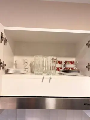 a white shelf with plates and cups and glasses at Apartment in Lima close to everything in Lima