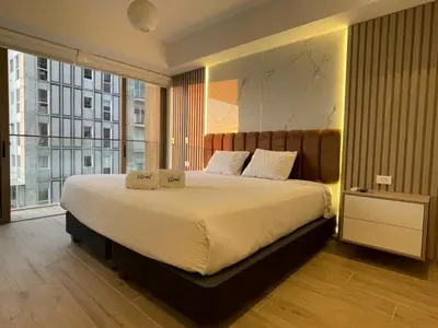a bedroom with a large bed and a large window at The Modern Studios by Vibrant in Lima