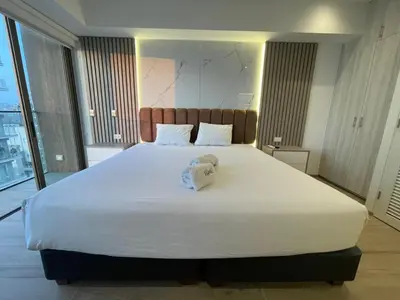 a bedroom with a large bed with a towel on it at The Modern Studios by Vibrant in Lima