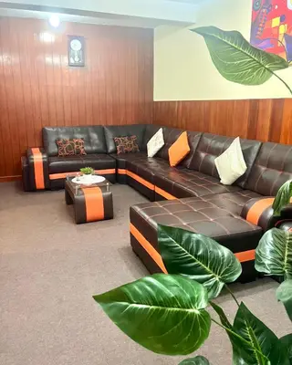 a living room with a leather couch and a table at Slaviero Home Cusco III in Cusco