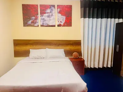 a bedroom with a white bed and two pictures on the wall at Slaviero Home Cusco III in Cusco