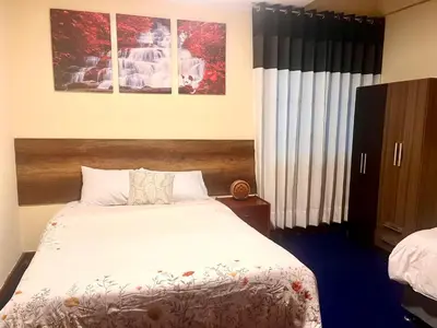 a bedroom with a bed and two pictures on the wall at Slaviero Home Cusco III in Cusco