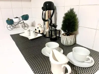 a black and white counter with cups and a coffee maker at Slaviero Home Cusco III in Cusco