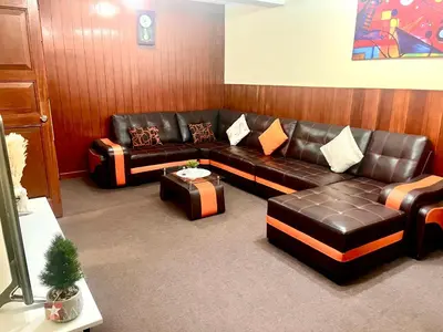 a living room with a leather couch and a table at Slaviero Home Cusco III in Cusco
