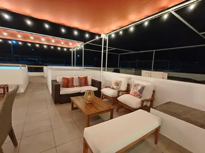 a living room with chairs and tables and lights at Casa de Playa en Puerto Viejo, Condominio Kalua in San Antonio