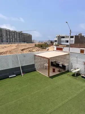 a pavilion on top of a building with green grass at Departamento 201 in Punta Negra