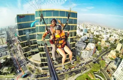 a man and a child riding on a zip line at Vital Building - Modern Apartment Miraflores in Lima