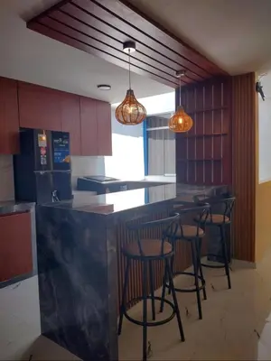 a kitchen with a bar with stools in it at Casa Quevedo in Ica