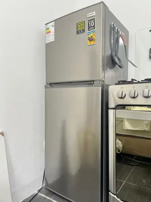 a stainless steel refrigerator in a kitchen next to a stove at Habitación equipada en san juan de Lurigancho in Lima