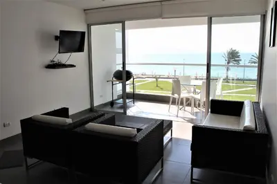 a living room with a view of the ocean at Departamento con Vista al Mar - Paracas - Condominio Nautico Las Velas in Paracas