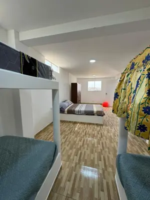a bedroom with two beds and a bunk bed at Amplia casa petfriendly con parrilla cerca a Asia in Salitre