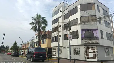 a van parked in front of a building on a street at Boulevard home hostel - Lima Airport in Lima
