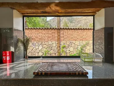 a room with a large window in a building at Cancha Wasi A modern, cozy and fully equipped house in Urubamba