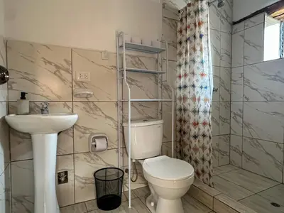 a bathroom with a toilet and a sink at Cancha Wasi A modern, cozy and fully equipped house in Urubamba