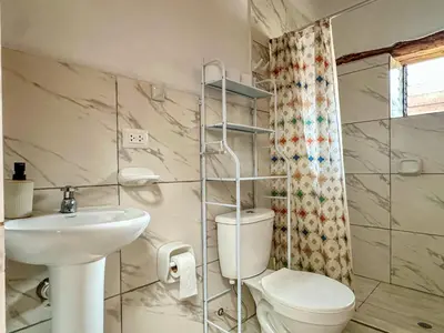 a bathroom with a toilet and a sink at Cancha Wasi A modern, cozy and fully equipped house in Urubamba