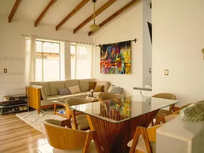 a living room with a glass table and a couch at Mountain retreat with private sauna in Urubamba in Urubamba