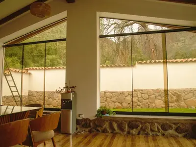 a large window in a room with a table and chairs at Mountain retreat with private sauna in Urubamba in Urubamba