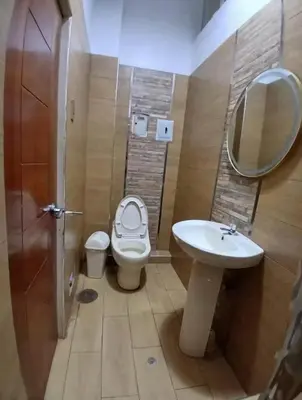 a bathroom with a toilet and a sink and a mirror at Princess Hotel in Supe