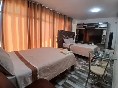 a hotel room with two beds and a flat screen tv at Princess Hotel in Supe