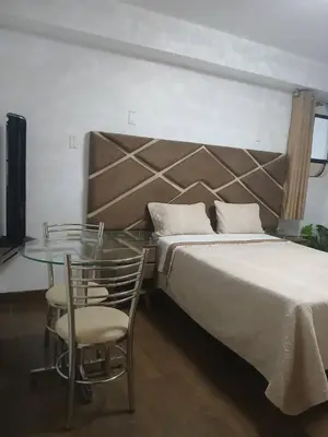 a bedroom with a bed and a glass table at Princess Hotel in Supe