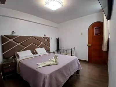 a mermaid sitting on a bed in a bedroom at Princess Hotel in Supe