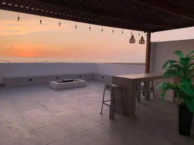 a dining room with a table and a view of the ocean at Topará Beach House in San Vicente de Cañete