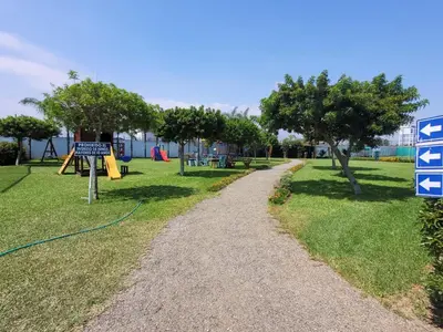 a gravel path in a park with a playground at Casa de playa Cala del Mar Experience in Bujama Baja